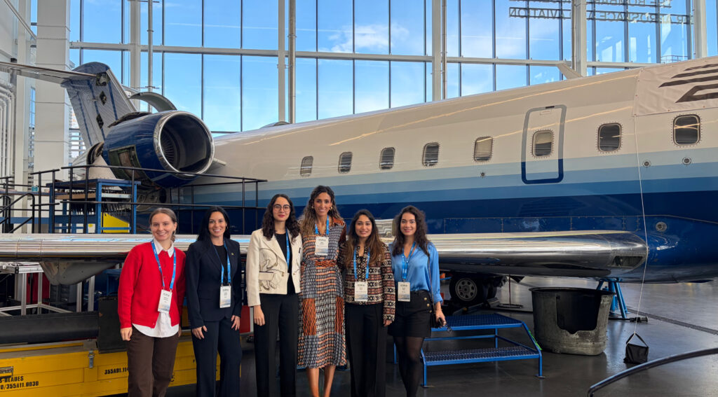 WIA-Canada team at DAIR To Innovate 2025, in front of an aircraft in the Downsview hangar