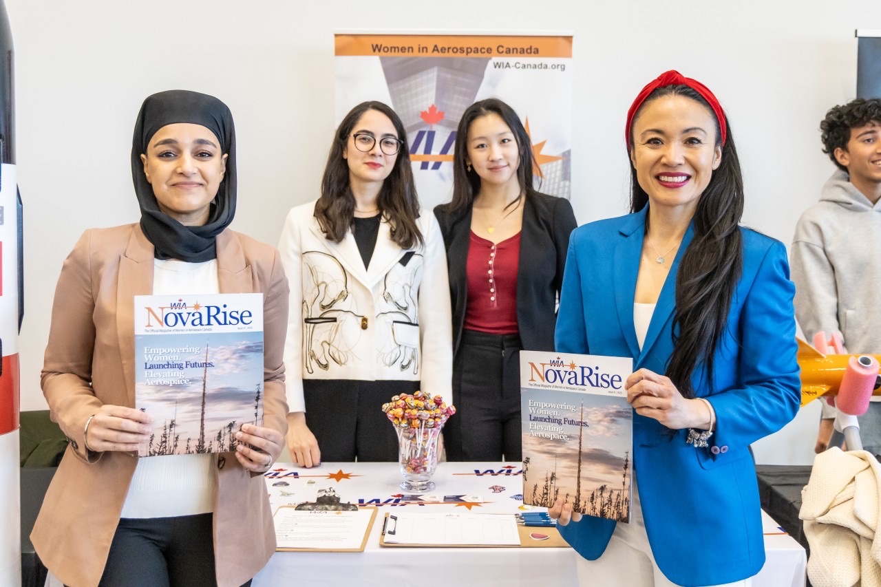 Students visiting the WIA-Canada table at Moonshot