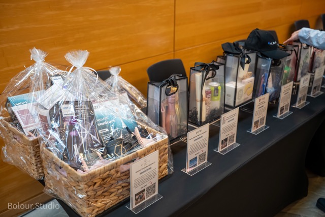 Silent auction items on display at InspireHER 2026